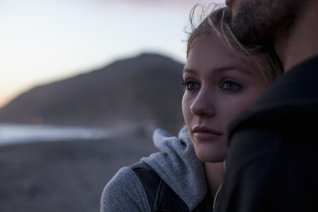 Couple hugging on beach, Malibu, California, USA